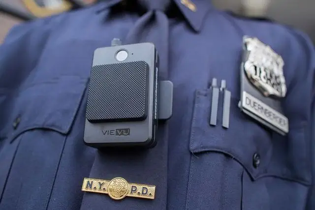 A police officers wearing the Vievue mode LE-4 body camera office outside the 34th precinct